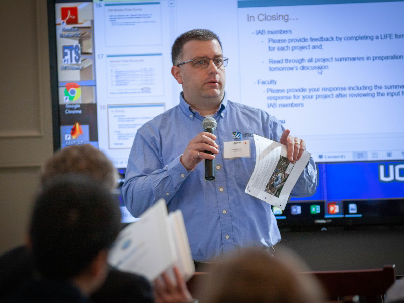 a man speaking at a workshop in front of an audience